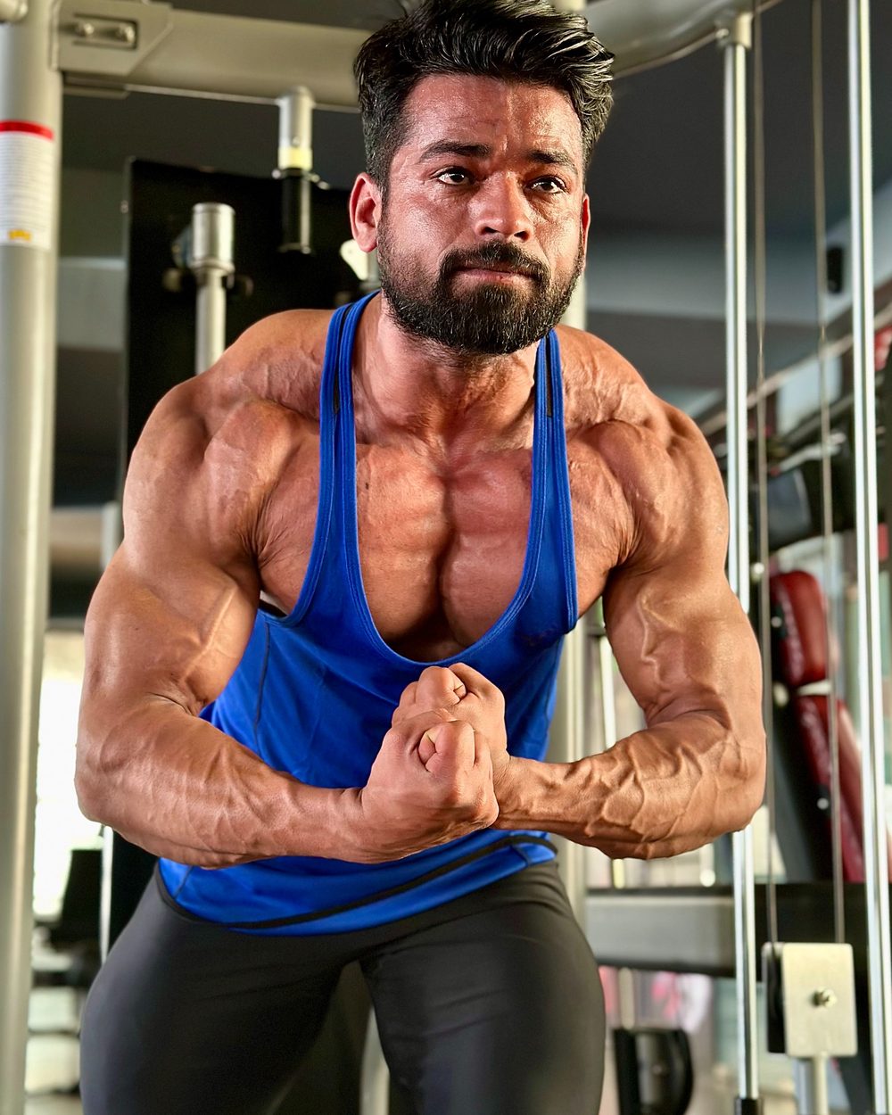 Amit, your coach, hitting a most muscular pose in the gym